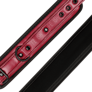 Detail shot of a BDSM ankle cuffs made from vegan leather in red and black colour