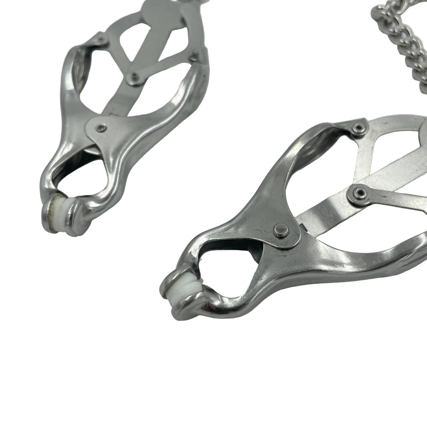 Detail shot of a set of silver BDSM clover nipple clamps with chain